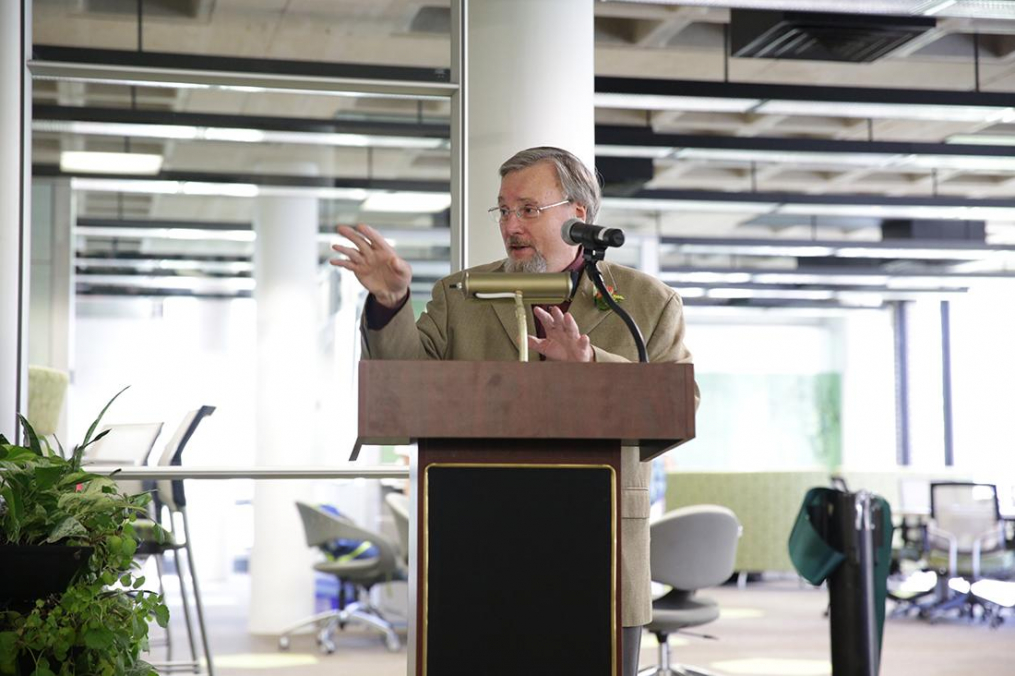 Donald Wertman stands at a podium in Lightner Library