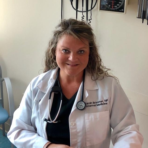 Portrait of Sarah in her white coat in her hospital